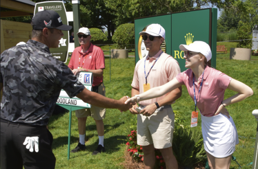 Professional golfer Francesco Molinari shakes hands with staff at the Travelers Championship in Cromwell, CT.