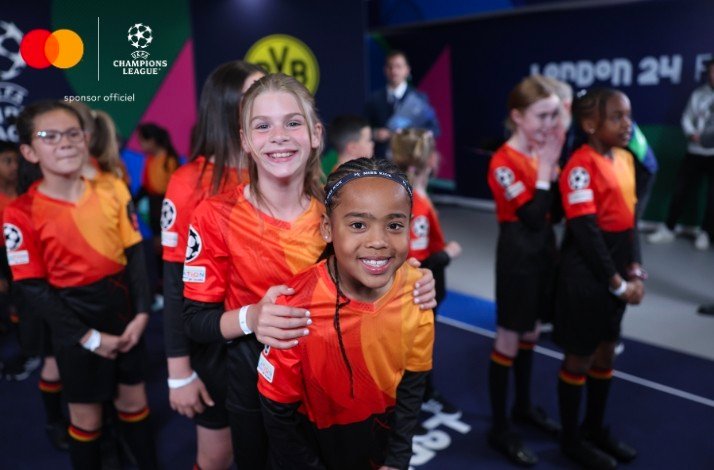 Two young girls smiling and enjoying the moments at the backstage of the stadium.