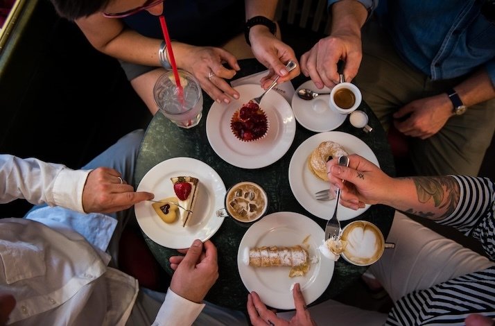 Customers enjoy delicious desserts during an exclusive culinary tour of Old Town Prague.