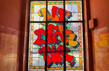 Colorful stained-glass window in a Prague passage.