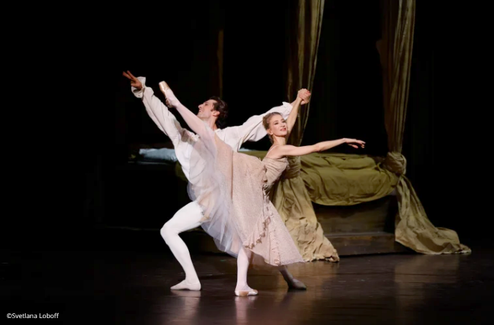 A male and female ballet dancer perform a passionate duet from L Histoire de Manon on a theatrical stage.