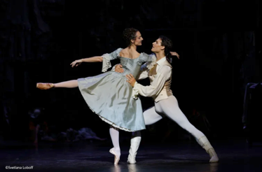 A male and female ballet dancer perform a passionate duet from L Histoire de Manon on a theatrical stage.