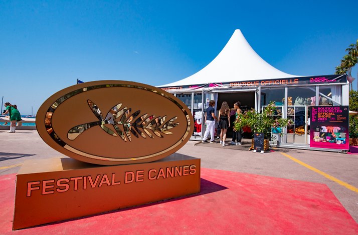 A golden Cannes Film Festival logo on the red carpet of the event