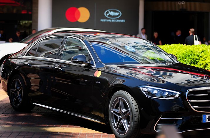 A luxury black car near the Cannes Festival location