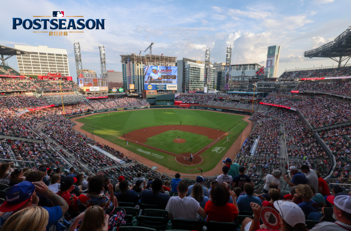 MLB Postseason 2026 day game at Truist Park, showing a capacity crowd in Braves colors and the Atlanta skyline in the background. 
