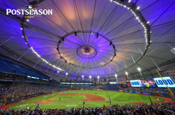 MLB Postseason 2026 game at Tropicana Field, Tampa Bay Rays' domed stadium glowing purple with fans filling the seats.