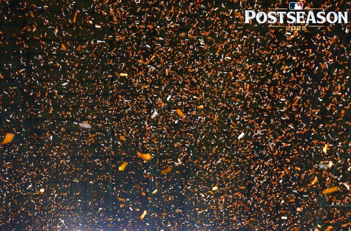 Promotional poster for Postseason MLB 2025, a lot of confetti with the colours orange and white 