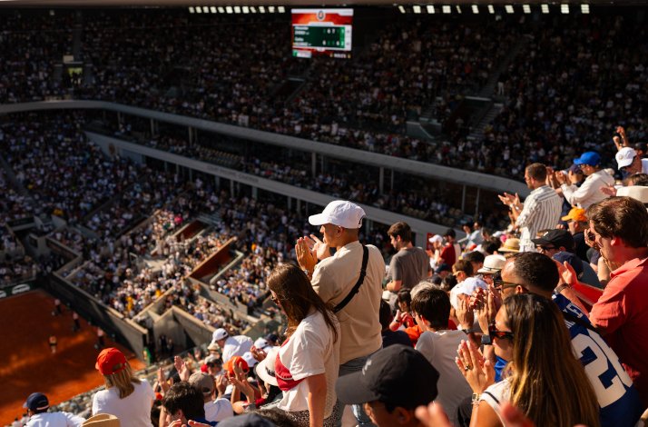 Fans cheering up during a match in Roland-Garros stadium.