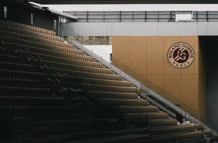 Rolland Garros stadium seats with dark lighting.