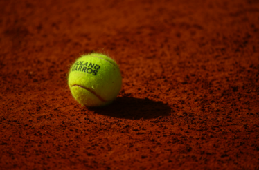 Tennis ball with Roland-Garros logo.