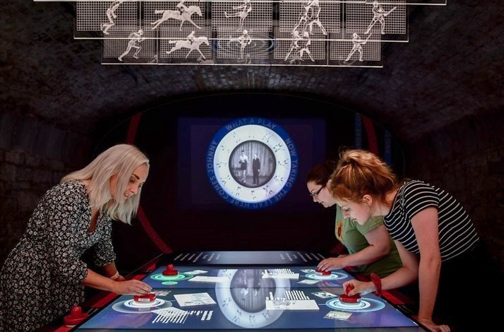 Visitors interacting with digital exhibits at EPIC The Irish Emigration Museum in Dublin.