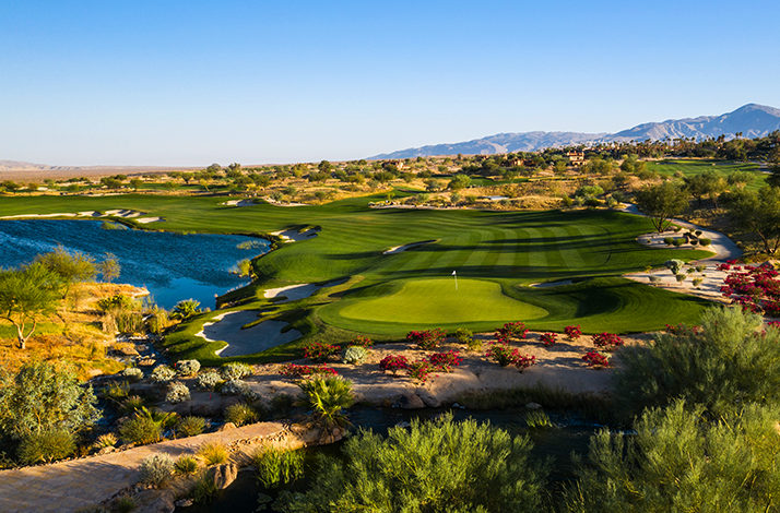 Lush green golf course hole at Rams Hill Golf Club in Borrego Springs, California.