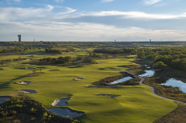 Aerial view of PGA Frisco golf course with lush fairways, bunkers, and water features.