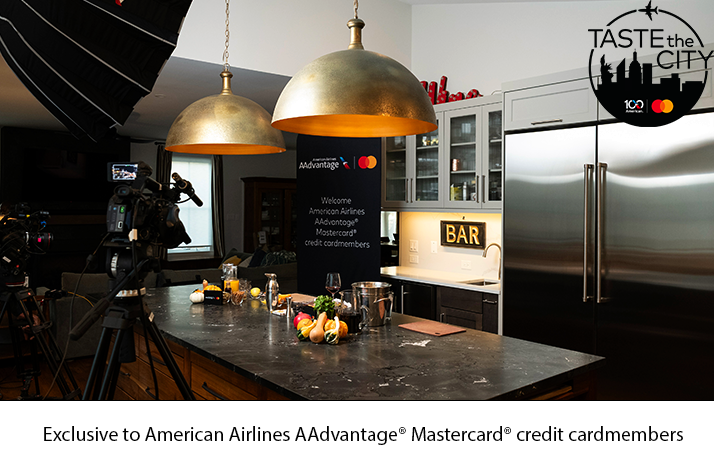 Cameras aimed at the kitchen with a Mastercard in Collaboration with American Airlines banner in the background.