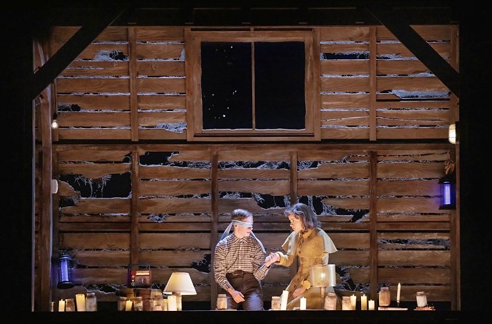 Scene from the Broadway's Stranger Things: The First Shadow performance: blindfolded boy holds a girl’s hand.
