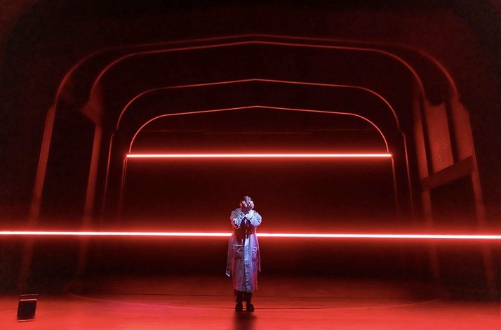 Scene from the Broadway's Stranger Things: The First Shadow performance: person standing in the middle of the stage and covering face with hands.