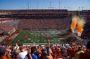 Packed Texas stadium with fans and kickoff atmosphere.