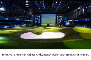 Indoor golf arena with digital screens and a putting green at SoFi Center.