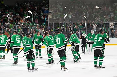 The Dallas Stars players are skating on the ice at the American Airlines Center.