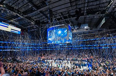 The crowds at the American Airlines Center cheering over a confetti release during a live NBA Dallas Mavs home game 