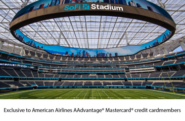 A panoramic view of the SoFi Stadium, showing the field, seats, and massive oval video board.