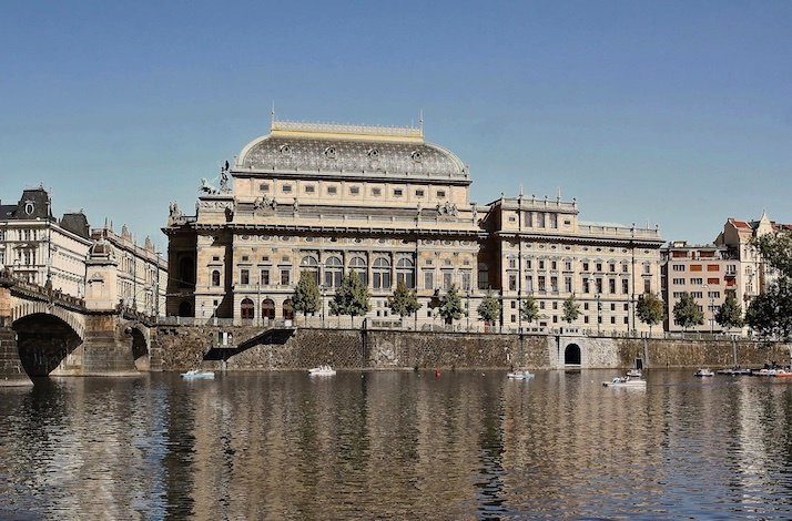 View at the embankment of Vltava river with a building of the Prague National Theatre.