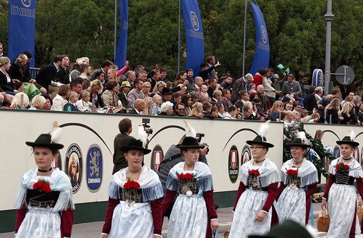 Traditional costume parade, with big crowds on the stands, at the Oktoberfest.