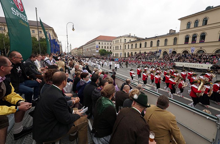 Traditional costume parade, with big crowds on the stands, at the Oktoberfest.