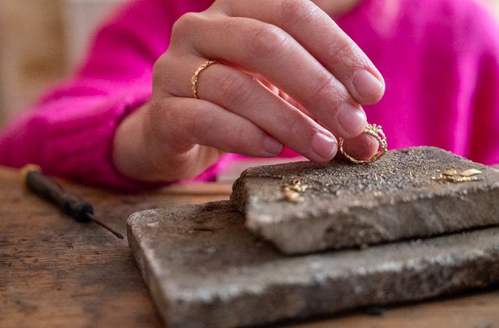 Gold ring by jeweller Anais Rheiner on display.