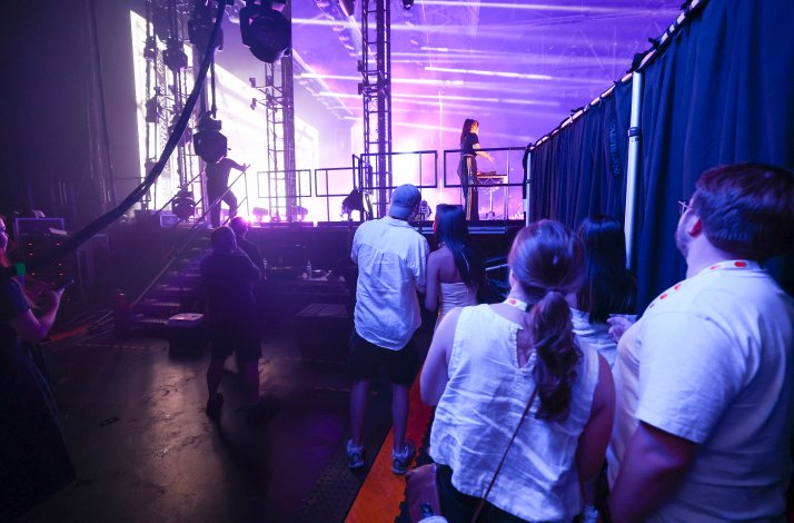 A group of people standing at backstage at Australian Open Arena.