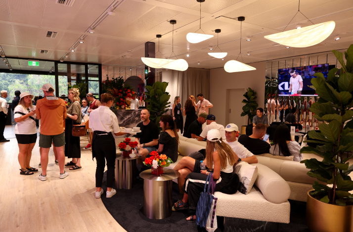 Guests relax and socialize in the Mastercard lounge, watching tennis on TV.