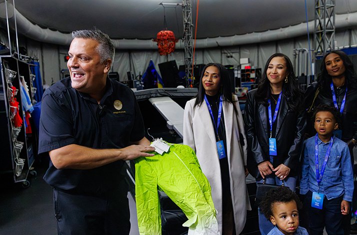 A staff assistant demonstrates costumes of the cirque cast to visitors at Cirque du Soleil's International Headquarters.