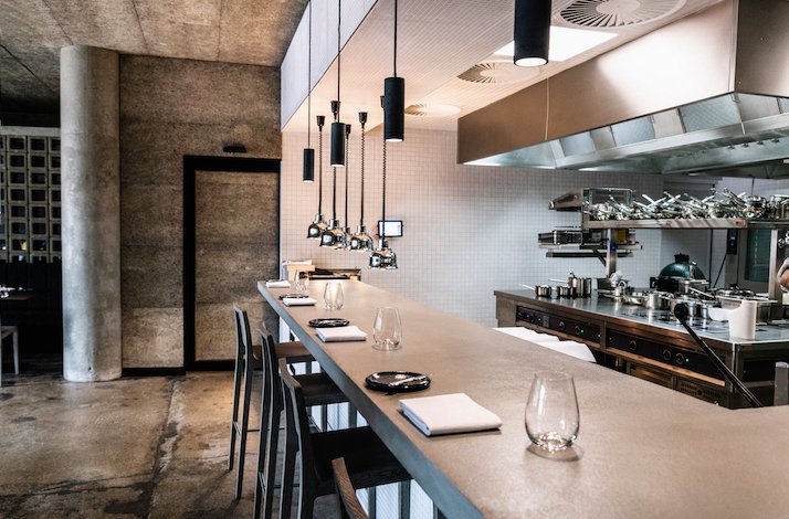 Dining area with a view of the kitchen at The Eatery.
