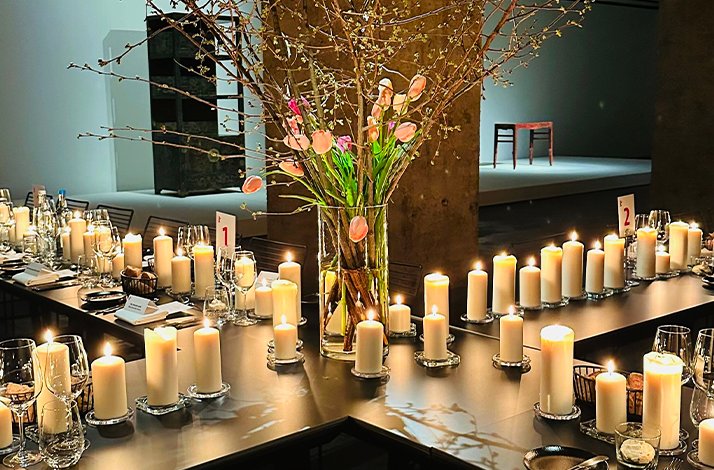 The table is set with multiple wine glasses and place settings, with simple paper place cards visible.