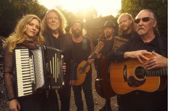 This image features Robert Plant performing with his band Saving Grace, which includes vocalist Suzi Dian.