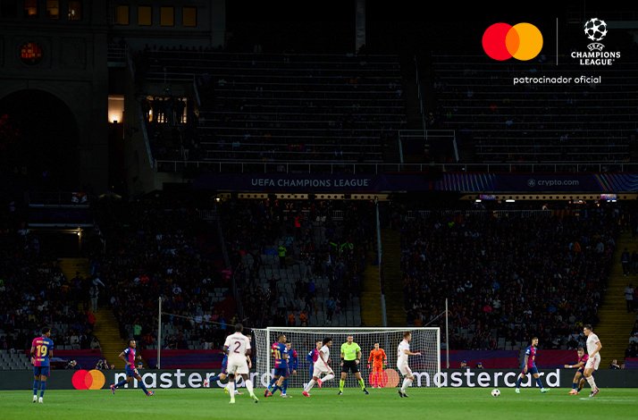 Footballers playing during UEFA champions league game.
