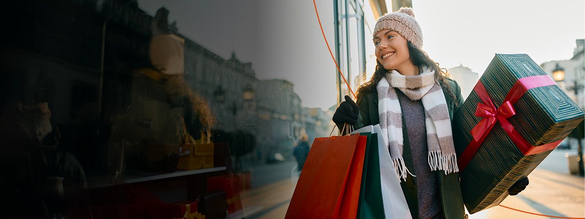 Smiling woman holding gift packages