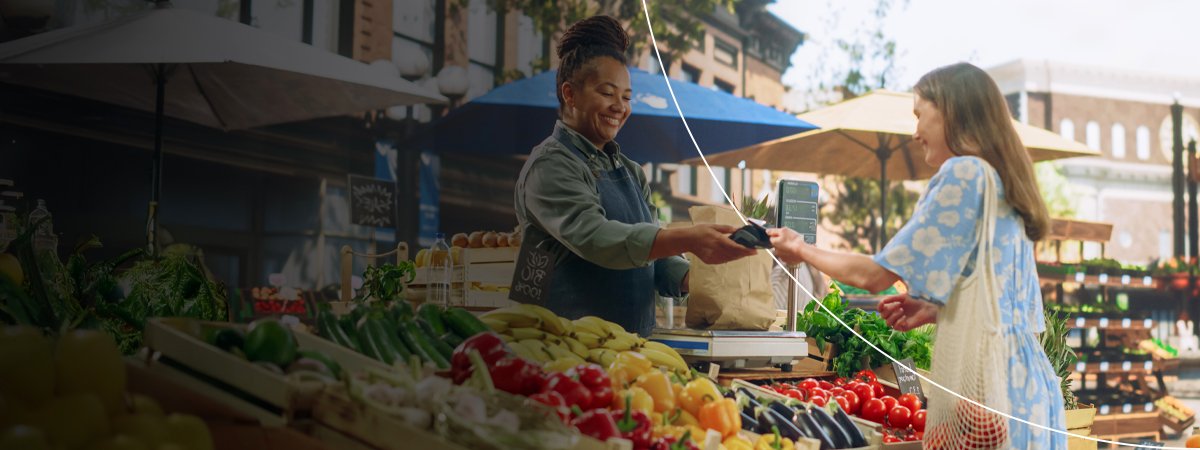 A shopper paying for groceries with a Mastercard card