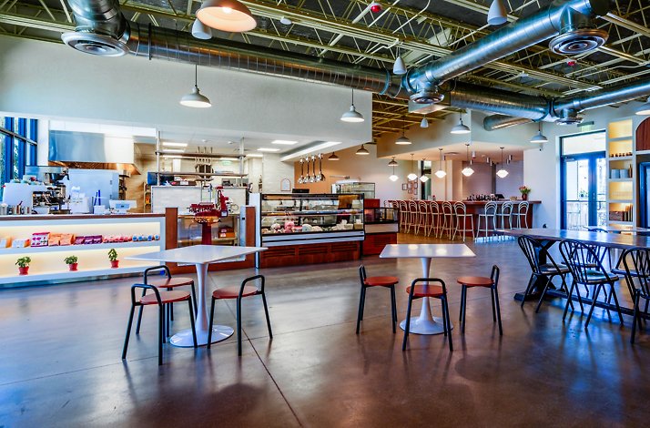 The spacious, modern rustic interior of the pizzeria and wine market Bar Bucce in Miami, Florida.