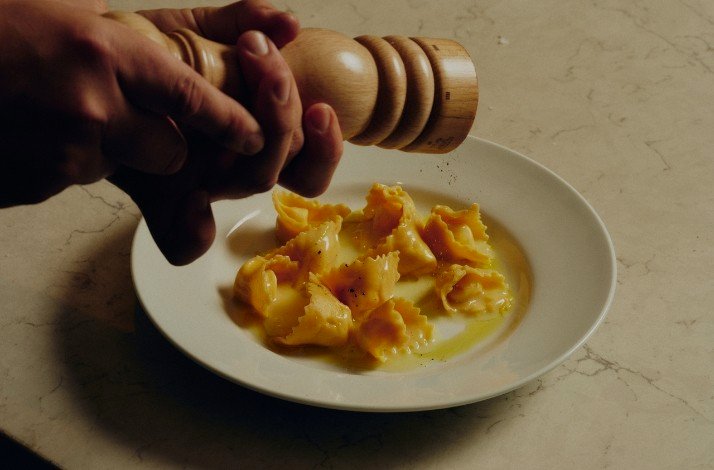 Homemade ravioli being seasoned with pepper at Antico Nuovo restaurant in Los Angeles.