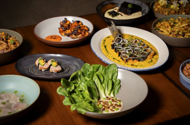 Overhead arrangement of Kayao Chicago tasting menu courses, showcasing contemporary Peruvian dishes with Japanese and Chinese influences.