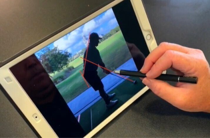 A viewer analyses the correct posture when playing golf using the video tips.