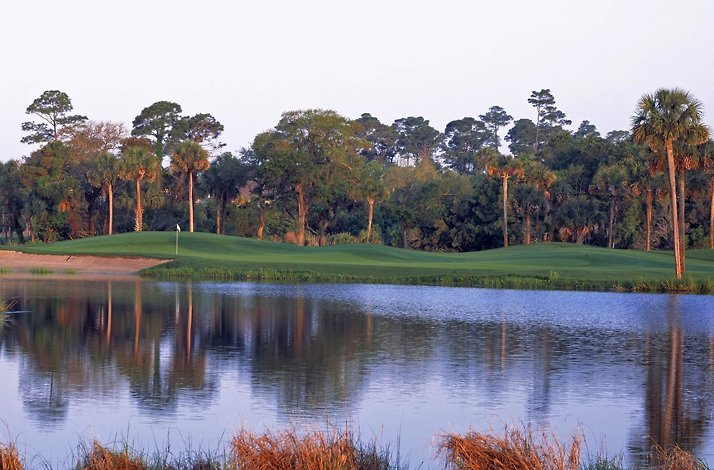 The Osprey Point Golf Course at Kiawah Island Golf Resort, featuring a prominent saltwater lagoon and maritime forest backdrop.