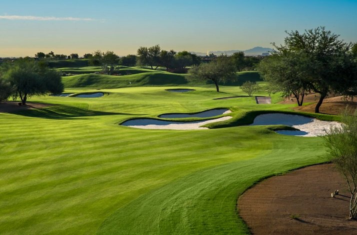 Scottsdale golf course with rolling greens, sand bunkers, and scattered trees.