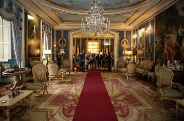 Grand salon adorned with exquisite chandeliers, luxurious furnishings, and stunning art