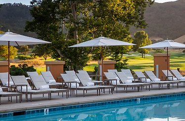 Sun loungers put in line at a large pool.