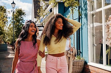 Two women smiling on the street