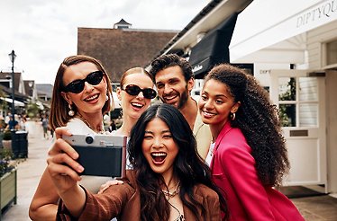 A company of friends having fun taking a selfie on the old camera