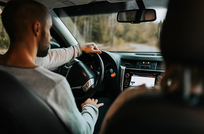 A person driving a vehicle following a GPS