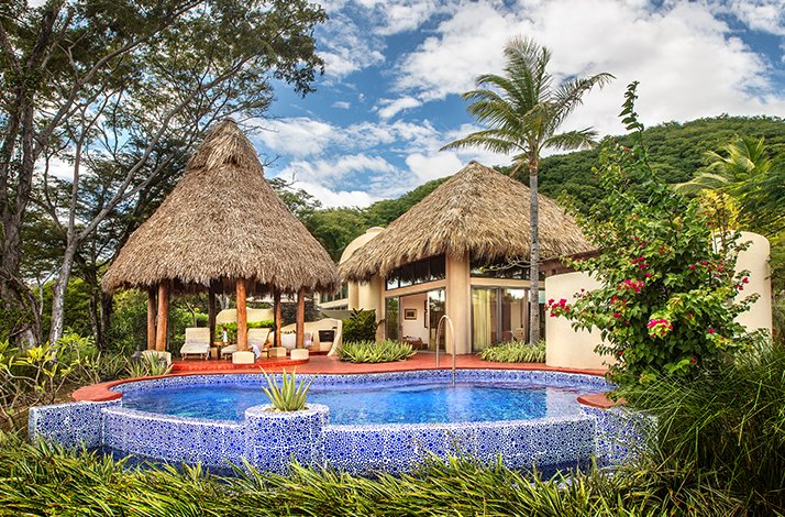 Outdoor huts and swimming pools at Preferred Hotels & Resorts.